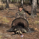kid holding gobbler turkey